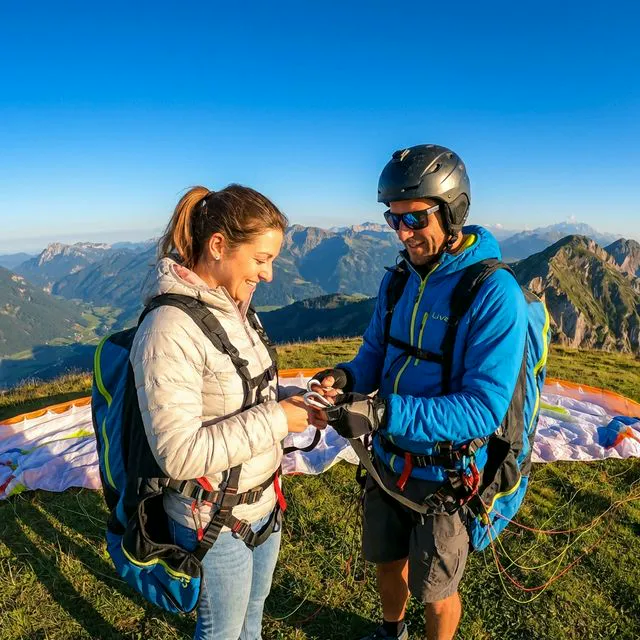 Tandem Paragliding Pilot explaining equipment and safety procedures